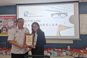 A man and woman holding a certificate